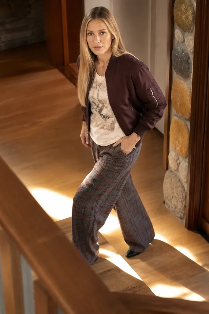 Wide plaid trousers with a graphic tank and a cropped bomber
