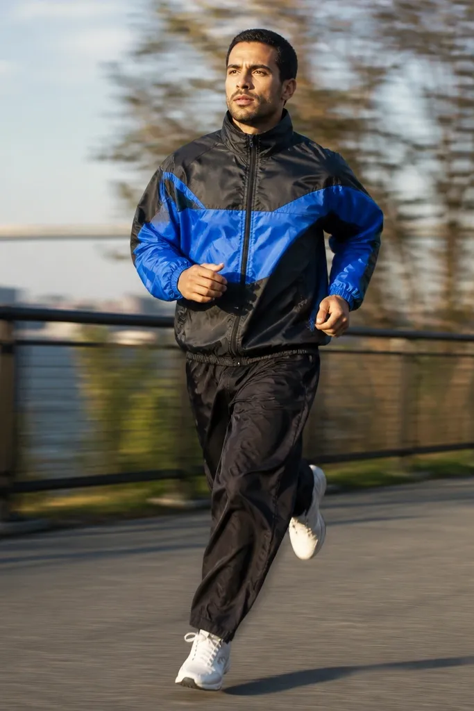 Two-tone windbreaker with baggy black pants and white sneakers