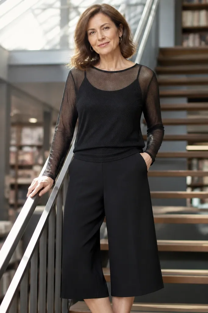 Black long sleeve mesh layered over a cami with wide-leg culottes