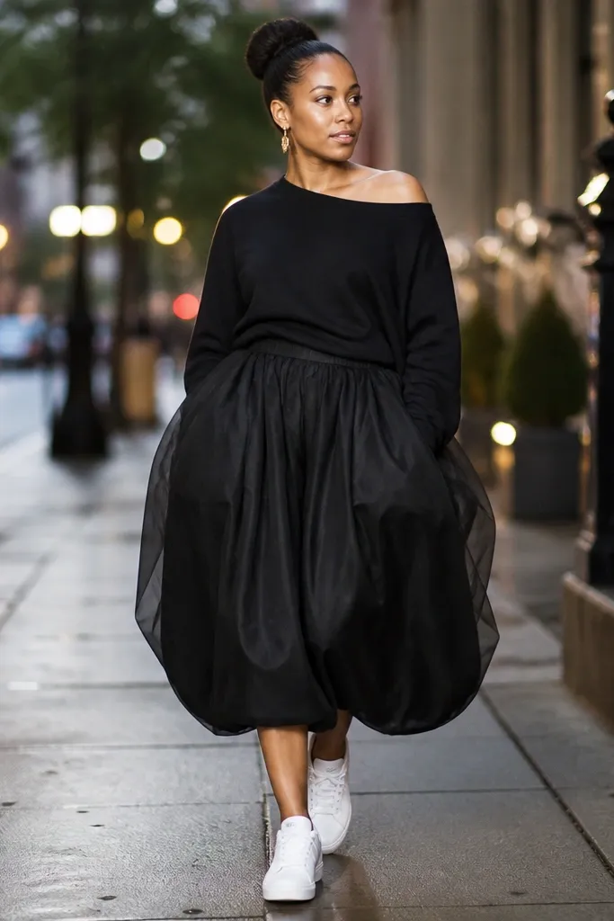 Black off-shoulder sweatshirt with black bubble skirt and white sneakers