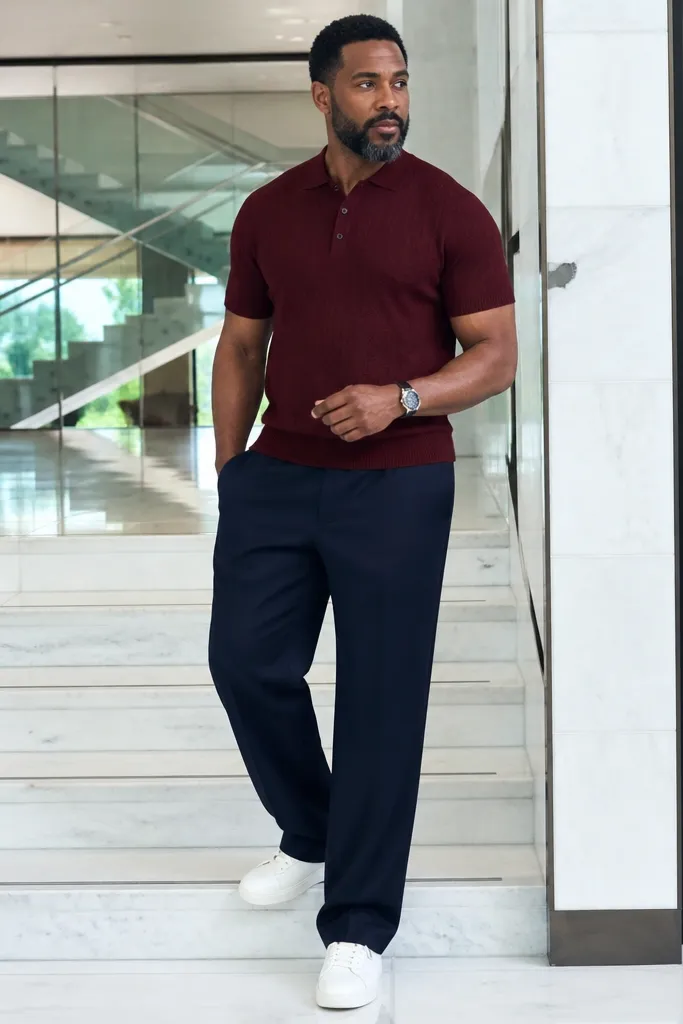 Burgundy knit polo with wide-leg navy trousers and white sneakers
