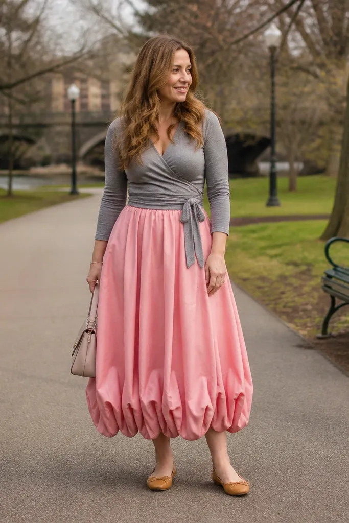 Pink bubble maxi skirt with a gray long-sleeve wrap top and ballet flats