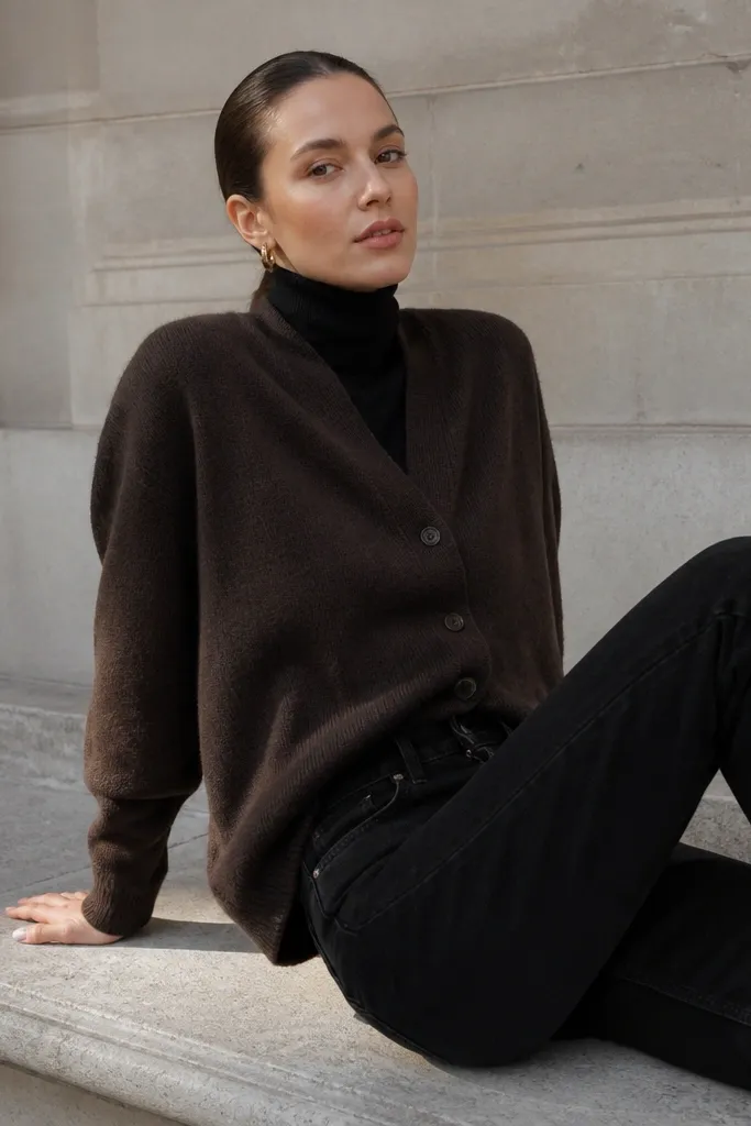 Black turtleneck under a chocolate cardigan with black straight jeans