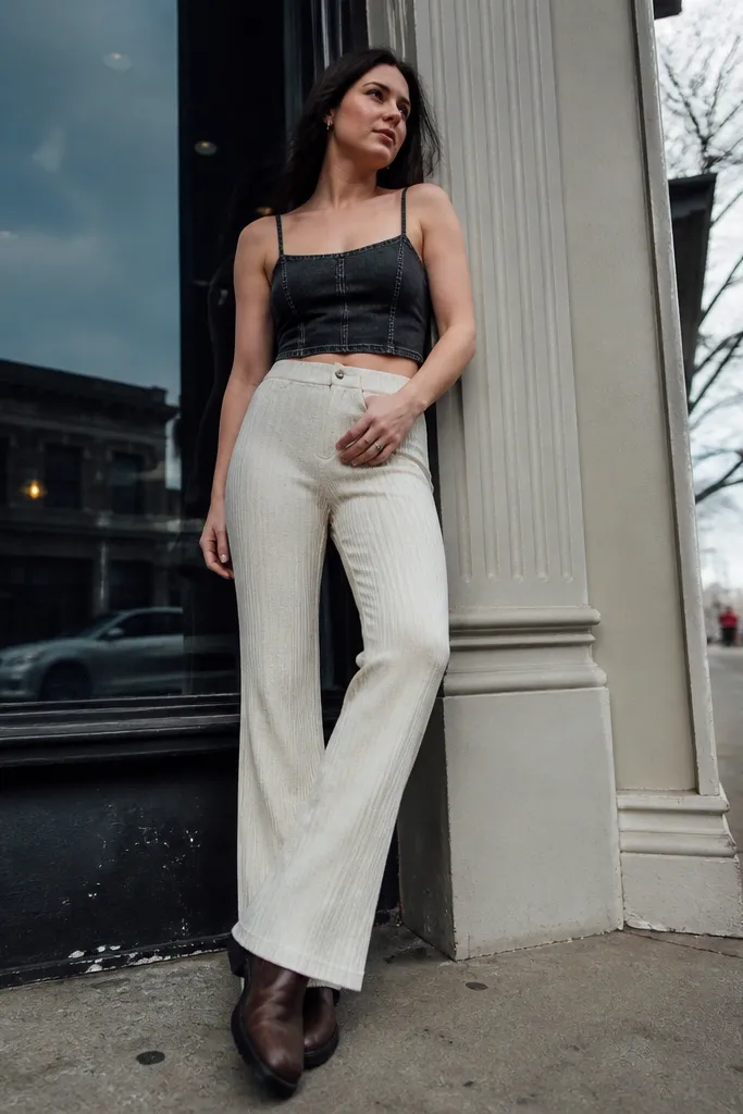 Black denim crop top with cream ribbed pants and espresso boots