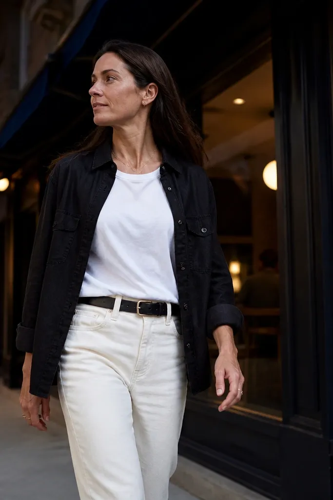 Black denim overshirt worn over a white tee with cream chinos and brown boots