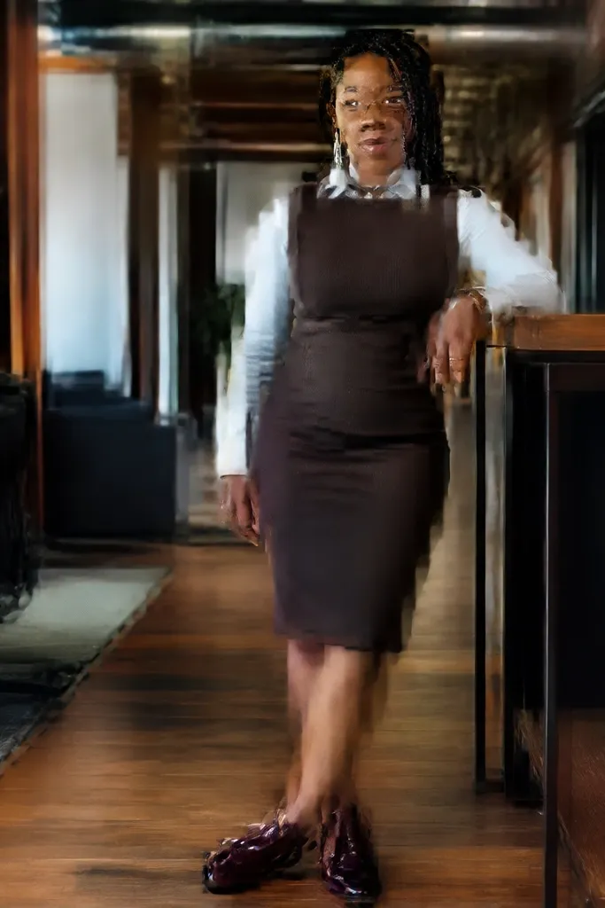 Chocolate pencil dress with a white oxford shirt peeking at the neckline and dark brown derby shoes