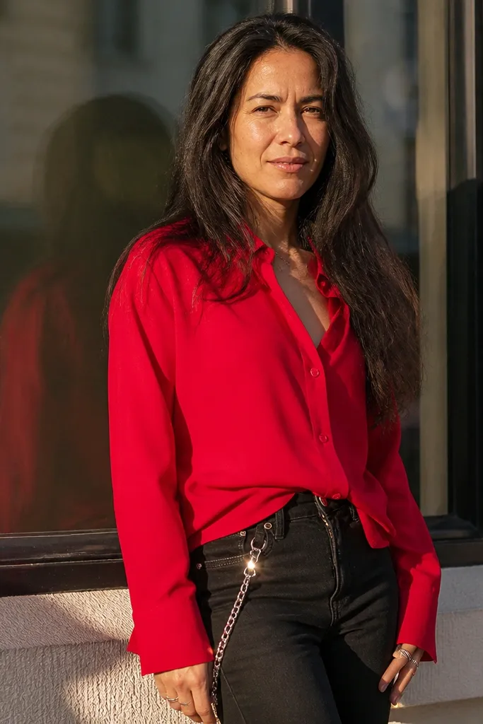 Red button-up with black jeans and a silver chain