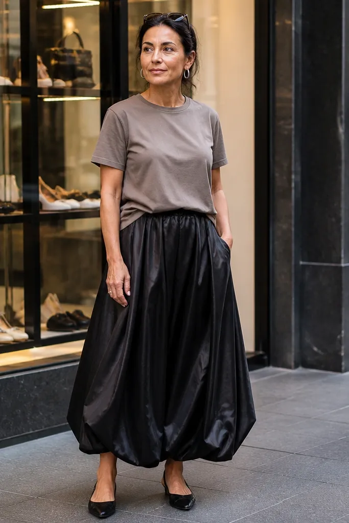 Black velvet or satin long bubble skirt with a taupe tucked tee and black boots