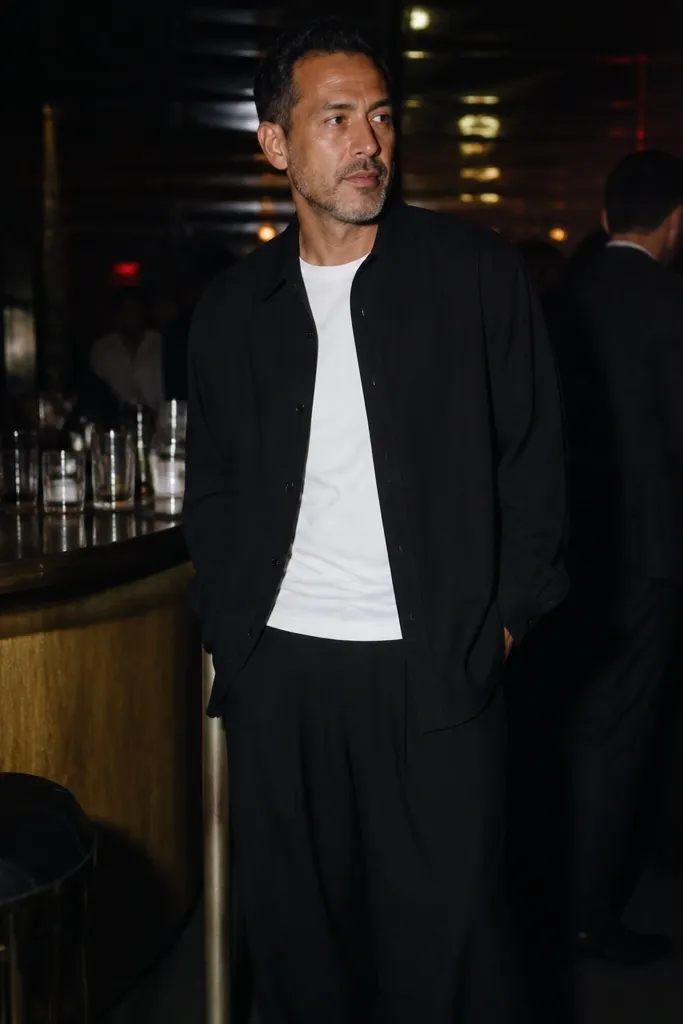 White tee with oversized black trousers and black overshirt and black sneakers