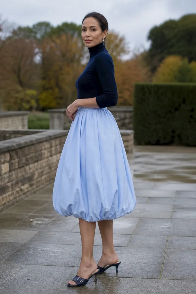 Navy fitted turtleneck with a light blue bubble skirt and heeled mules